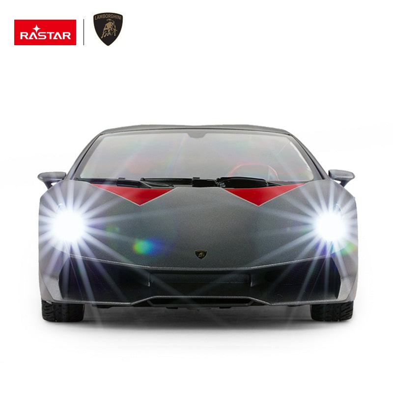Rastar 1:14 Lamborghini Sesto Elemento RC car in dark grey shown front-on with both bright LED headlights illuminated, highlighting the aggressive front splitter and Lamborghini badge.