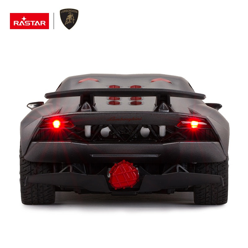 Rear view of the Rastar 1:14 Lamborghini Sesto Elemento RC car in dark grey with red LED tail lights illuminated, showcasing the exposed engine cover, rear diffuser, and large central exhaust.
