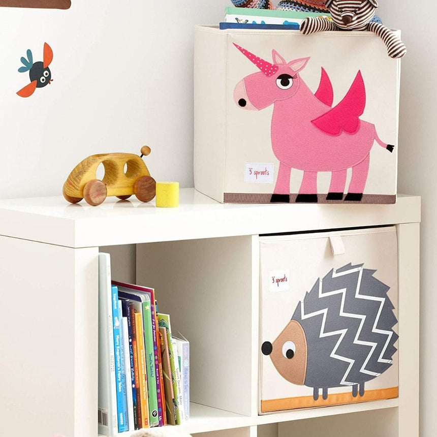 Children's storage boxes with animal designs on a white shelf.