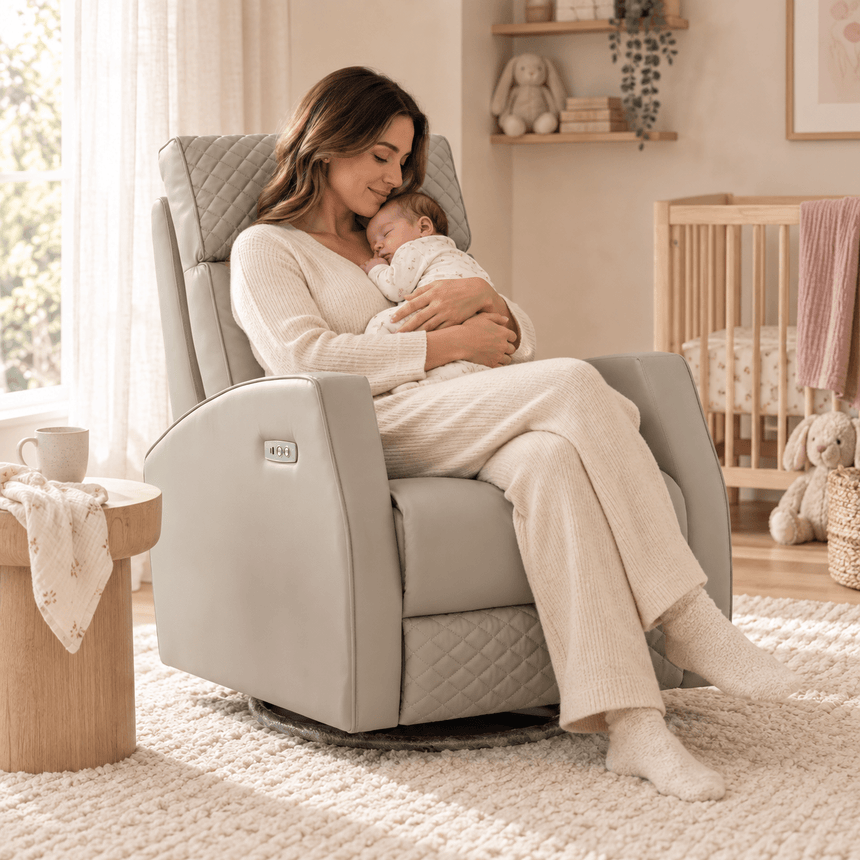 Parent holding a baby in the Marlo light grey leather-look nursery recliner chair