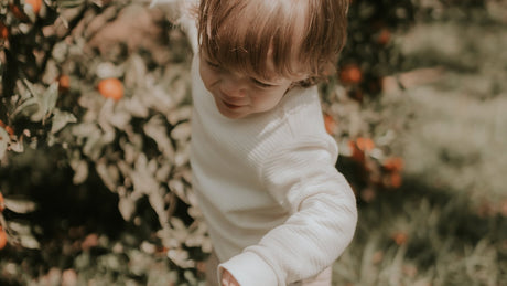 Toddler enjoying outdoor play, choosing between a push car and electric ride-on