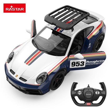 Rastar 1:14 Porsche 911 Dakar Performance RC car shown from a front three-quarter overhead angle in white and navy blue "Roughroads" #953 Dakar race livery, with both doors open, roof rack visible, and the steering-wheel-style remote controller displayed beside it.