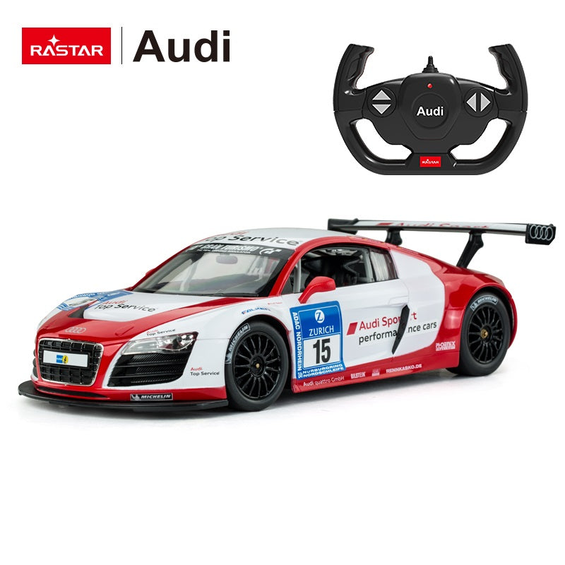 Rastar 1:14 Audi R8 LMS Performance RC car in red and white #15 "Audi Sport Top Service" race livery, photographed from a right side three-quarter angle alongside the Audi-branded steering-wheel remote controller, showing the large rear wing, full race graphics, and the Gran Turismo windscreen banner.