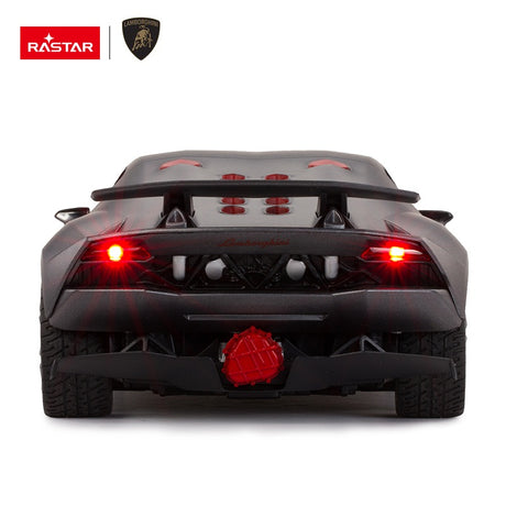 Rear view of the Rastar 1:14 Lamborghini Sesto Elemento RC car in dark grey with red LED tail lights illuminated, showcasing the exposed engine cover, rear diffuser, and large central exhaust.