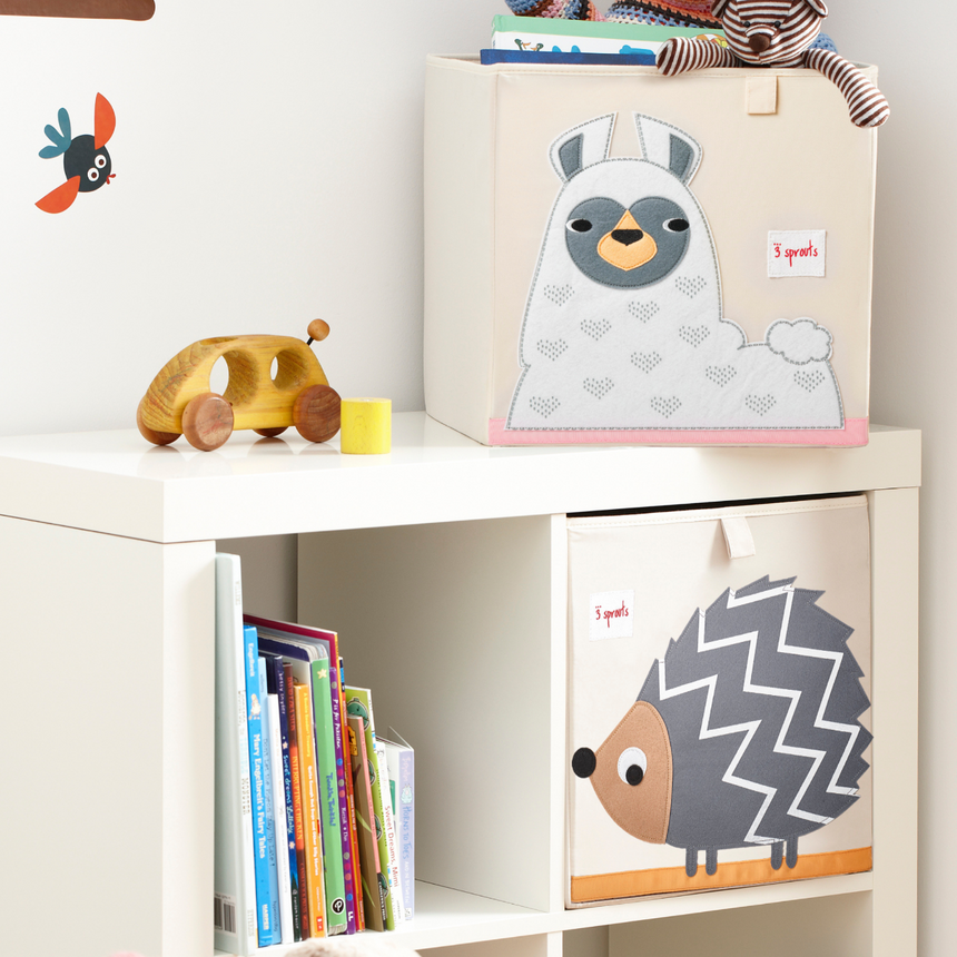 Children's toy storage unit with animal-themed boxes and toys on a white shelf.
