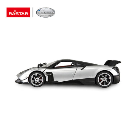 Rastar 1:14 Pagani Huayra BC RC car in silver and carbon fibre finish, pure side profile view with doors closed, showcasing the low-slung supercar silhouette, rear wing, and five-spoke alloy wheels.