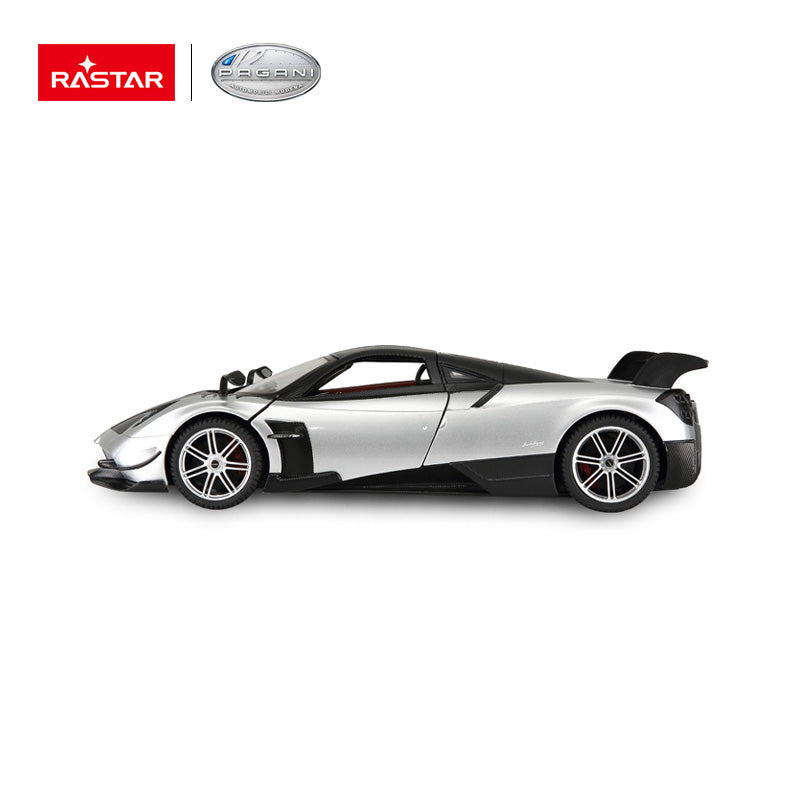 Rastar 1:14 Pagani Huayra BC RC car in silver and carbon fibre finish, pure side profile view with doors closed, showcasing the low-slung supercar silhouette, rear wing, and five-spoke alloy wheels.