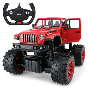 Rastar 1:14 Jeep Wrangler Rubicon Big Foot RC car in red at a front 3/4 angle with driver-side door open, shown with its Jeep-branded steering-wheel remote controller; the oversized knobby bigfoot tyres with red rims and heavy-duty suspension springs are prominently displayed.