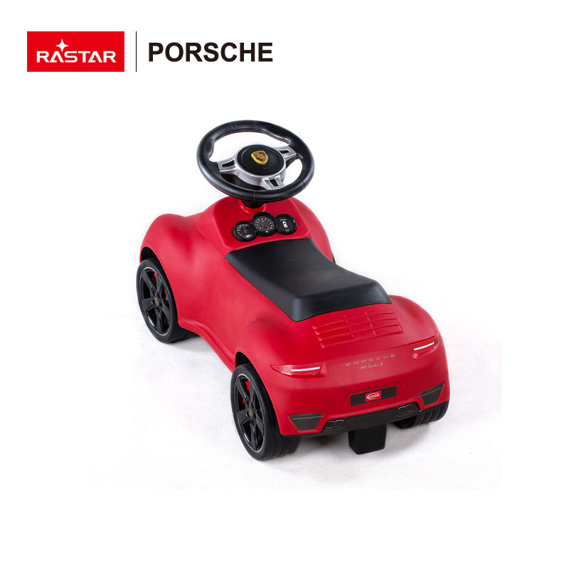Child riding Rastar Licensed Porsche 911 foot to floor push car