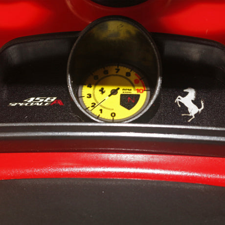 Child riding Rastar Licensed Ferrari 458 foot to floor push car