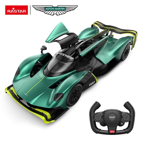 Rastar 1:14 Aston Martin Valkyrie AMR Pro RC car in racing green with neon yellow accents and number 002, viewed from an overhead 3/4 angle with butterfly gull-wing door open, showing the Valkyrie canopy cockpit, Aston Martin wings badge, and the car's ultra-low aerodynamic body; Aston Martin-branded steering-wheel remote controller shown alongside.