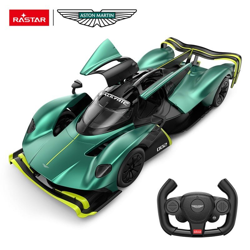 Rastar 1:14 Aston Martin Valkyrie AMR Pro RC car in racing green with neon yellow accents and number 002, viewed from an overhead 3/4 angle with butterfly gull-wing door open, showing the Valkyrie canopy cockpit, Aston Martin wings badge, and the car's ultra-low aerodynamic body; Aston Martin-branded steering-wheel remote controller shown alongside.
