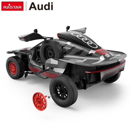 Rastar 1:14 Audi RS Q e-tron E2 RC car in dark grey and red livery shown from a high rear 3/4 angle with gull-wing doors open, and a detached red spare wheel beside the car to show the DIY wheel-change feature.
