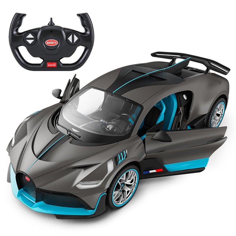 Rastar 1:14 Bugatti Divo RC car in matte grey with teal/blue accents shown from front 3/4 angle with both doors open, revealing the blue-tinted interior, alongside the Bugatti steering wheel remote controller. Opening doors and the dramatic rear wing are prominently featured.