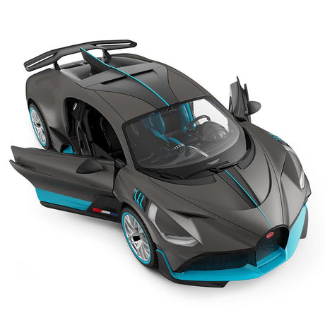 Rastar 1:14 Bugatti Divo RC car in matte grey with teal/blue accents viewed from overhead front 3/4 angle with both doors open wide. The large panoramic windscreen, central roof fin, blue interior detailing, and twin-element rear wing are visible from above.