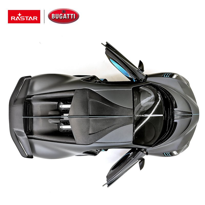 Rastar 1:14 Bugatti Divo RC car in matte grey with teal/blue accents shown from a rear 3/4 elevated angle with door open, displaying the Rastar and Bugatti co-branding logos. The carbon-look louvred engine deck, prominent rear wing, and blue door interior trim are highlighted.