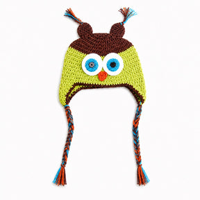 Crocheted owl hat with large embroidered eyes, a small orange beak, brown ear covers, and braided ear ties in blue, orange, and brown on a white background.