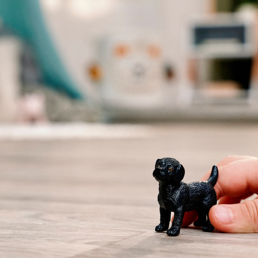 Schleich Black Labrador Retriever Puppy toy figure in play scene