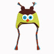 Crocheted owl hat with large embroidered eyes, a small orange beak, brown ear covers, and braided ear ties in blue, orange, and brown on a white background.