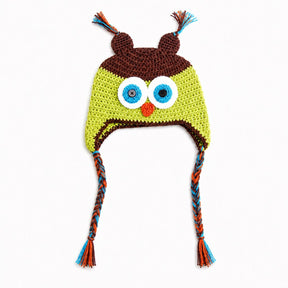 Crocheted owl hat with large embroidered eyes, a small orange beak, brown ear covers, and braided ear ties in blue, orange, and brown on a white background.