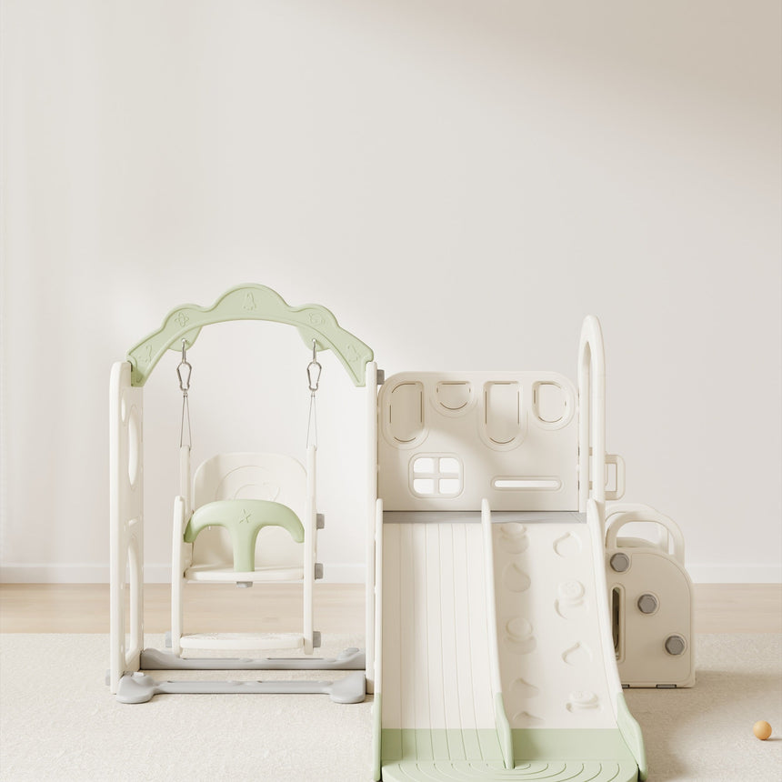 Willow Double Track Slide & Swing Play Center - toddler sitting at the bottom of the double-track slide