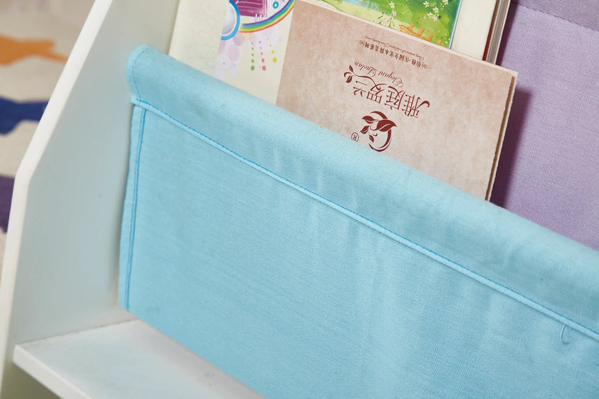 Detail of the blue canvas sling pocket on the Charlie White kids bookcase holding a storybook