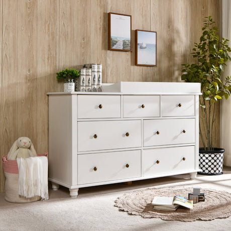 Modern white nursery dresser with changing tray, decor accents and plush bunny in cozy kids room