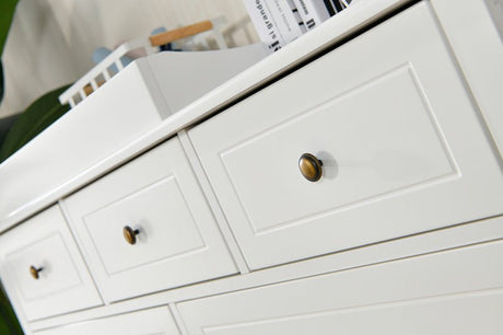 White nursery dresser with brass knobs and a changing tray, modern kids furniture