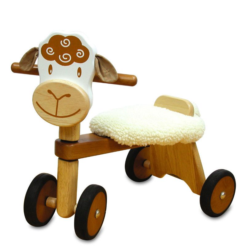 Toddler riding the I'm Toy Paddie Rider Lambie wooden ride-on sheep