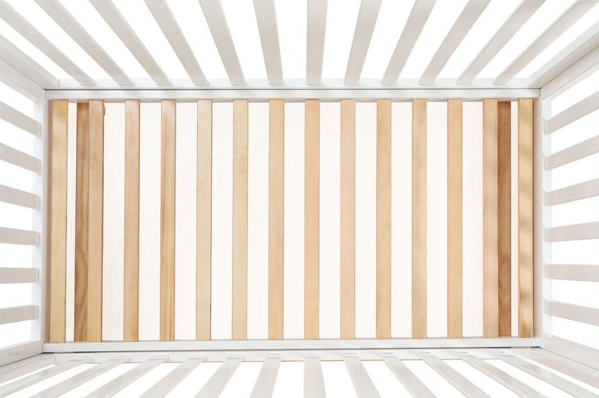 Top view of modern white and natural wood baby cot slats, nursery furniture