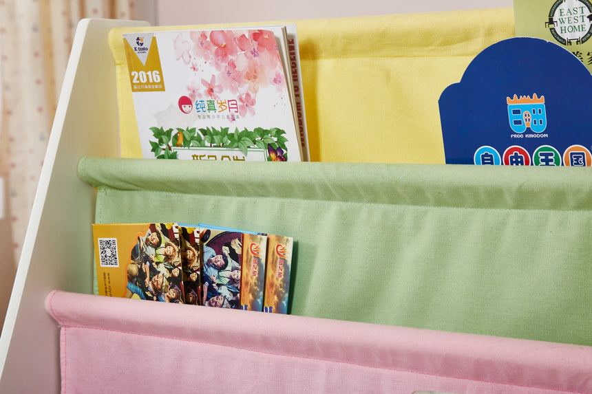 Close-up of the kids canvas sling bookcase pockets filled with children's books and magazines