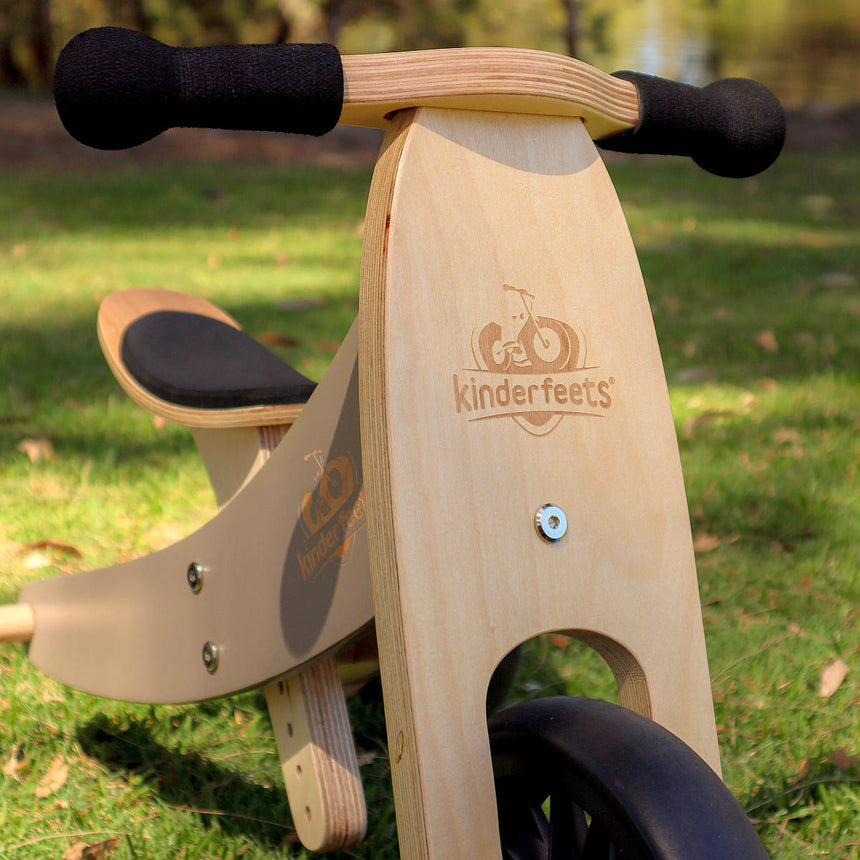 Close-up of the Kinderfeets Tiny Tot Plus birch handlebar, grips and cushioned seat