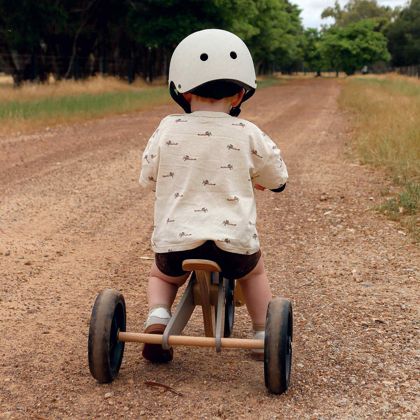 Rear view of a child riding the Kinderfeets Tiny Tot Plus Slate Grey trike