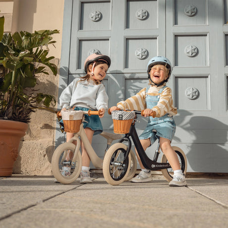 Toddler gliding on the lightweight Kinder Kraft Rapid 2 balance bike with basket